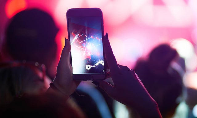 Person holding a smart phone recording a video