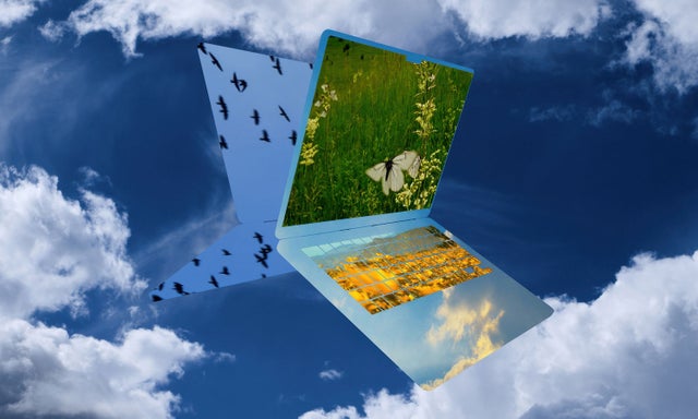 Floating laptop against a bright sky, blending technology with natural atmosphere.​